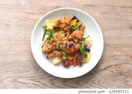 fried slice crispy chicken meat with cashew nut and bell pepper couple onion on plate fried slice crispy chicken meat with cashew nut and bell pepper couple onion on plate 128495711