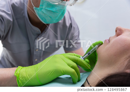 A Professional Cosmetic Procedure: Administering a Fillers Treatment to Enhance Facial Aesthetics in a Calm Clinical Environment with Proper Hygiene Practices Observed A Professional Cosmetic Procedure: Administering a Fillers Treatment to Enhance Facial Aesthetics in a Calm Clinical Environment with Proper Hygiene Practices Observed 128495867
