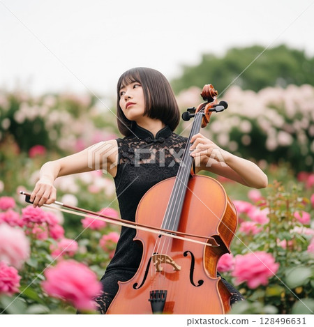 A passionate woman holding a cello surrounded by red roses A woman in a chic black Chinese dress 128496631