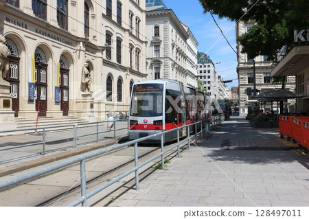 Vienna tram running along narrow streets 128497011