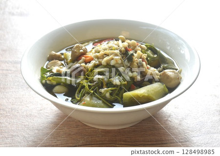 sweet Melientha suavis and mixed vegetable with red ant egg in fermenting fish sauce curry soup on bowl sweet Melientha suavis and mixed vegetable with red ant egg in fermenting fish sauce curry soup on bowl 128498985