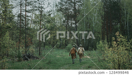 Group of Soldiers Walking Through Forest with Rifles 128499846