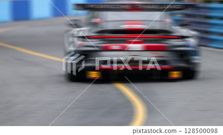 Motion blur race car racing on speed track, Motion blurred super car race on street track circuit, Automobile automotive transportation vehicle background, 128500098
