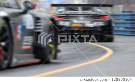 Motion blur race car racing on speed track, Motion blurred super car race on street track circuit, Automobile automotive transportation vehicle background, 128500104