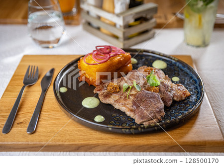Delicious grilled pork with potato gratin 128500170