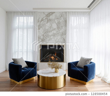 Cozy modern living room with marble fireplace and stylish seating arrangement in bright natural light 128500454