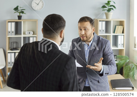 Angry business people colleagues disputing having disagreement fighting at workplace 128500574