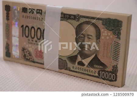 Money, stack of bills, million yen Money, stack of bills, million yen 128500970