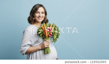 Smiling pregnant woman holding fresh vegetable bouquet. Healthy eating, maternal health, and joyful expectancy. 128502003