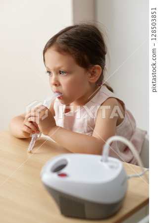 cute little toddler girl making inhalation with nebulizer cute little toddler girl making inhalation with nebulizer 128503851