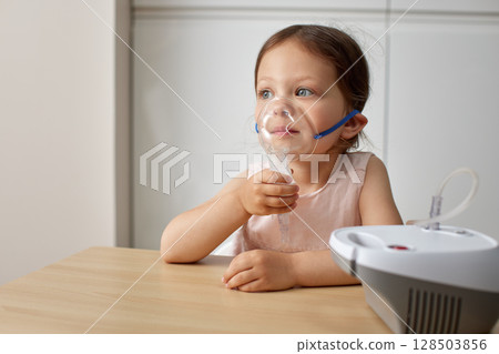cute little toddler girl making inhalation with nebulizer 128503856