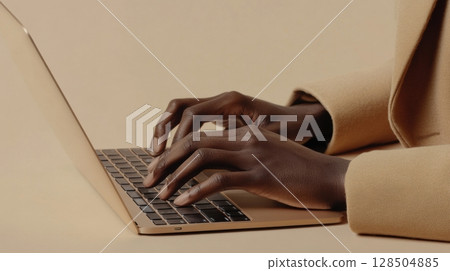 person typing on laptop computer 128504885