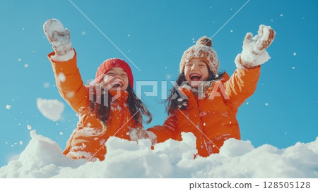 joyful sisters playing in the snow on a sunny day 128505128