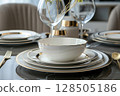 Tableware set with minimalist aesthetics, featuring sleek lines and premium finishes gold accents, luxury dining 128505186
