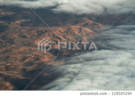 Aerial view of Madagascar landscape, with mountains and clouds. Aerial view of Madagascar landscape, with mountains and clouds. 128505294