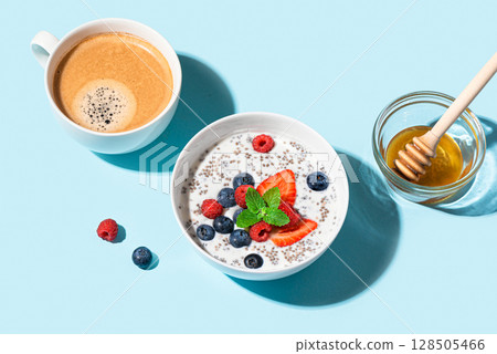 Healthy breakfast: chia bowl with berries and honey and coffee 128505466