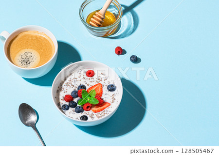 Healthy breakfast: chia bowl with berries and honey and coffee 128505467
