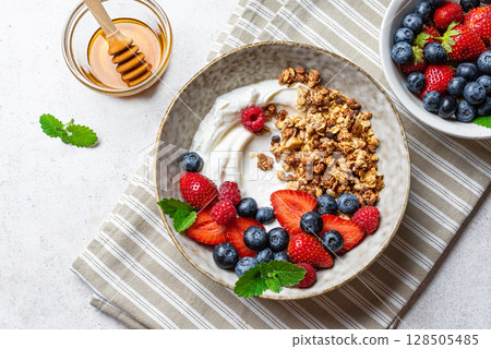 Granola bowl with greek yogurt and fresh berries Granola bowl with greek yogurt and fresh berries 128505485