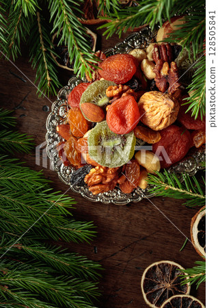 Assorted dried fruits and nuts on a silver tray. Assorted dried fruits and nuts on a silver tray. 128505841