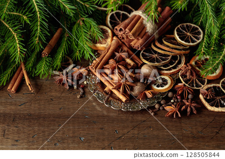 Various Christmas spices with dried citrus slices on silver tray. Various Christmas spices with dried citrus slices on silver tray. 128505844