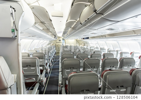 Inside empty wide body passenger aircraft cabin Inside empty wide body passenger aircraft cabin 128506104
