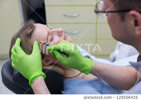 A Professional Aesthetic Procedure: Artistically Enhancing Beauty with Precision Indoors in a Clinical Environment with a Calm Patient and Experienced Practitioner A Professional Aesthetic Procedure: Artistically Enhancing Beauty with Precision Indoors in a Clinical Environment with a Calm Patient and Experienced Practitioner 128506428
