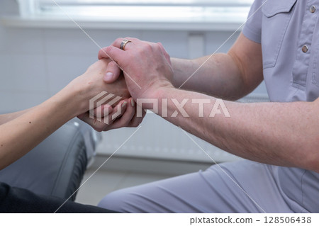 An intimate moment of support in a therapeutic setting, showcasing the intricate connection between patient and caregiver as they engage in a mutual hand-holding gesture of trust and empathy. An intimate moment of support in a therapeutic setting, showcasing the intricate connection between patient and caregiver as they engage in a mutual hand-holding gesture of trust and empathy. 128506438