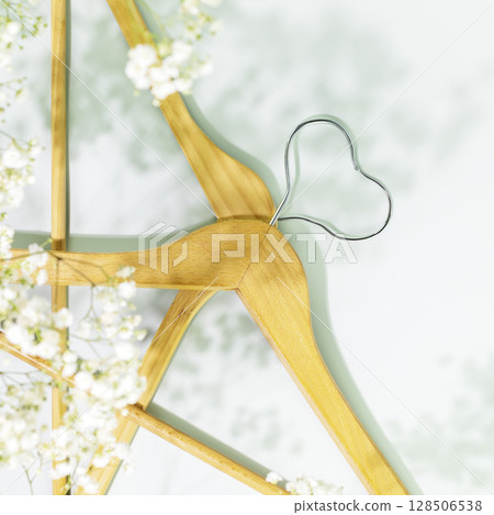 Creative spring shopping and sale concept. Wooden hangers in shape of heart with white spring flowers on light blue background. Fashion spring discounts shopping, sale store. Flat lay Creative spring shopping and sale concept. Wooden hangers in shape of heart with white spring flowers on light blue background. Fashion spring discounts shopping, sale store. Flat lay 128506538