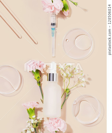 Concept of beauty injections. Syringe with toxin dropper bottle with serum and flowers on pink background. Cosmetic procedures for the face. Skin treatment and beauty care. Flat lay, vertical format Concept of beauty injections. Syringe with toxin dropper bottle with serum and flowers on pink background. Cosmetic procedures for the face. Skin treatment and beauty care. Flat lay, vertical format 128506814