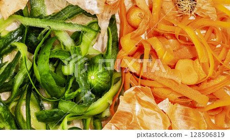 Closeup vegetable scraps ready for composting. Vegetable peelings on wrapping paper, set aside for compost. Concept of processing organic waste for fertilize soil. Flat lay 128506819
