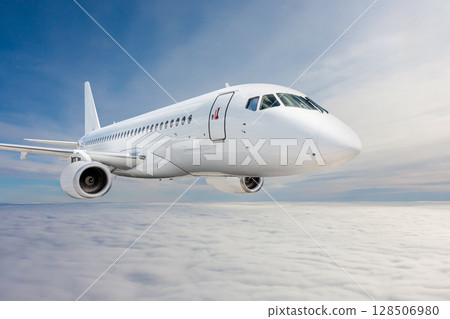 White passenger jetliner fly in the air above the clouds 128506980