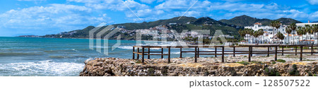 Wonderful landscapes of the shimmering sea and charming city unfold, offering breathtaking coastal views and a picturesque atmosphere in Nerja, Spain 128507522