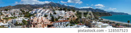 Wonderful landscapes of the shimmering sea and charming city unfold, offering breathtaking coastal views and a picturesque atmosphere in Nerja, Spain 128507523