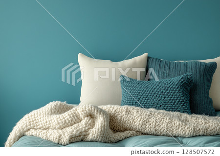 bedroom interior with plush pillows, soft blanket draping comfortably over bed, against calming wall World Sleep Day 128507572