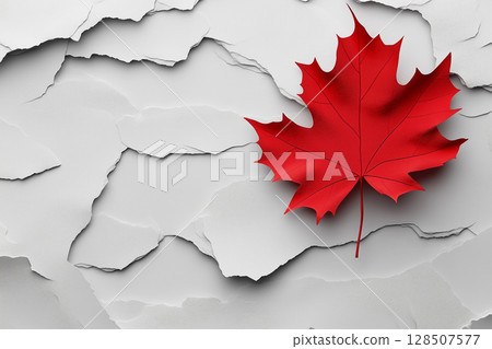 Red maple leaf, symbol of canada, lying on cracked white surface, representing challenges and difficulties faced by country copy space 128507577