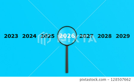 Lens, magnifying glass focusing on the year 2026 on a Blue background. Financial or stock market strategies and past and future events. 128507662
