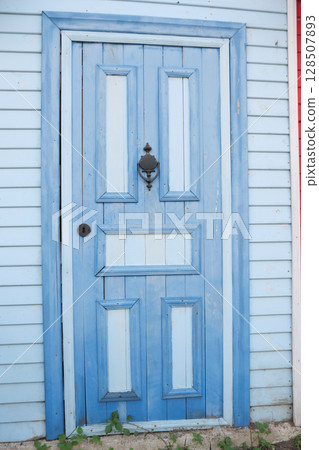 A Charming Blue Wooden Door Featuring an Elegant and Unique Design 128507893