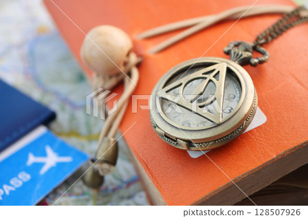Vintage compass placed on travel journal with map 128507926