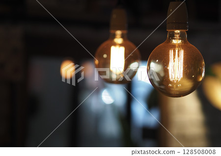 Warm light bulbs create inviting ambiance in cozy space 128508008