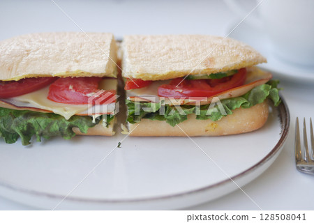 Fresh sandwich with lettuce, tomato, and turkey on plate Fresh sandwich with lettuce, tomato, and turkey on plate 128508041