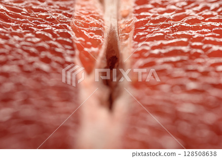 Detailed close-up photo of juicy red grapefruit slices. Macro photo of citrus fruits Detailed close-up photo of juicy red grapefruit slices. Macro photo of citrus fruits 128508638