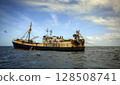 An old fishing trawler is fishing in distant oceanic waters. 128508741