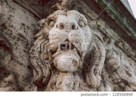 Close-up of stone lion's head decorating Vittorio Emanuele II Bridge over Tiber River in Rome, Italy. High quality photo 128508990