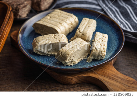 Halva. Sweet oriental dessert on plate on wooden table. 128509023