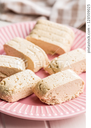 Halva. Sweet oriental dessert on plate. Halva. Sweet oriental dessert on plate. 128509025