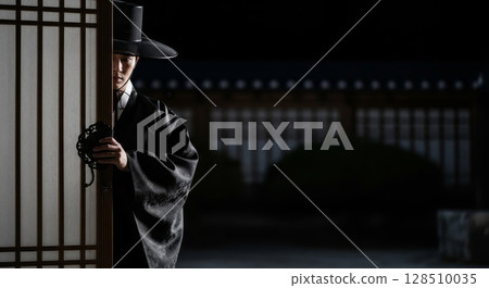 Korean grim reaper saja in black hanbok and gat peeking from traditional door at night 128510035