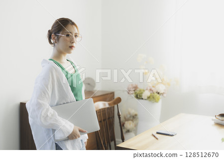 Woman wearing glasses using a laptop Woman wearing glasses using a laptop 128512670