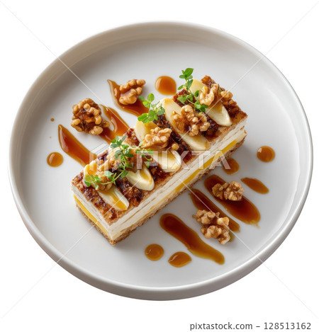 Roasted Jerusalem Artichoke Terrine Layered with Smoked Cheddar and Caramelized Pear on a Plate with Walnut Jus 128513162