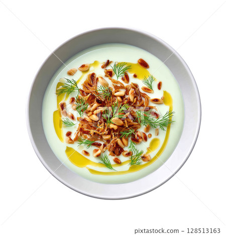 Creamy Pale Green Fennel Veloute Soup with Crispy Toppings and Drizzle of Anise Oil in a Shallow Bowl 128513163
