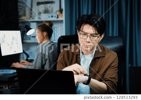 Businessman working laptop waiting email while coworker trading stock. Infobahn. Businessman working laptop waiting email while coworker trading stock. Infobahn. 128513293